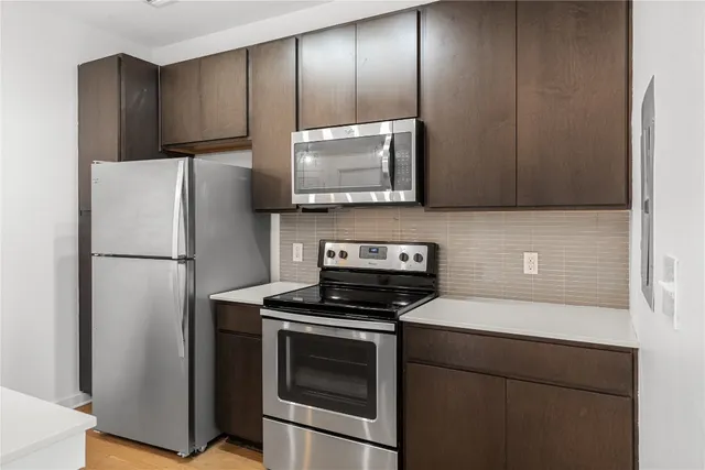 a kitchen with a refrigerator stove and microwave