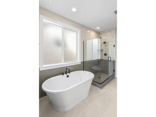 a bathroom with a bathtub and a sink