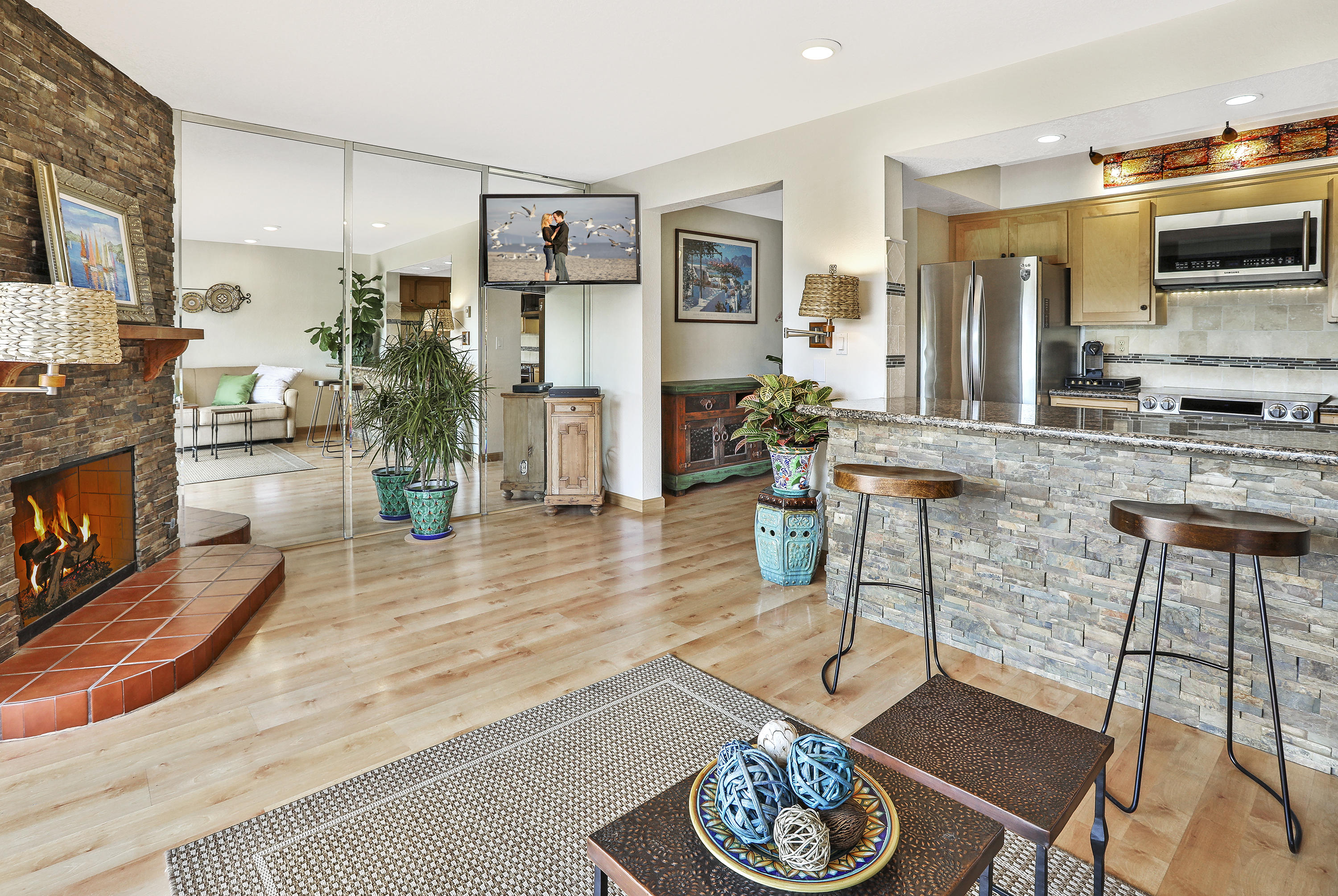 3375 Foothill Road, Unit 1012 Carpinteria, CA 93013 - Photo 2 of 15 a living room with furniture kitchen view and a wooden floor