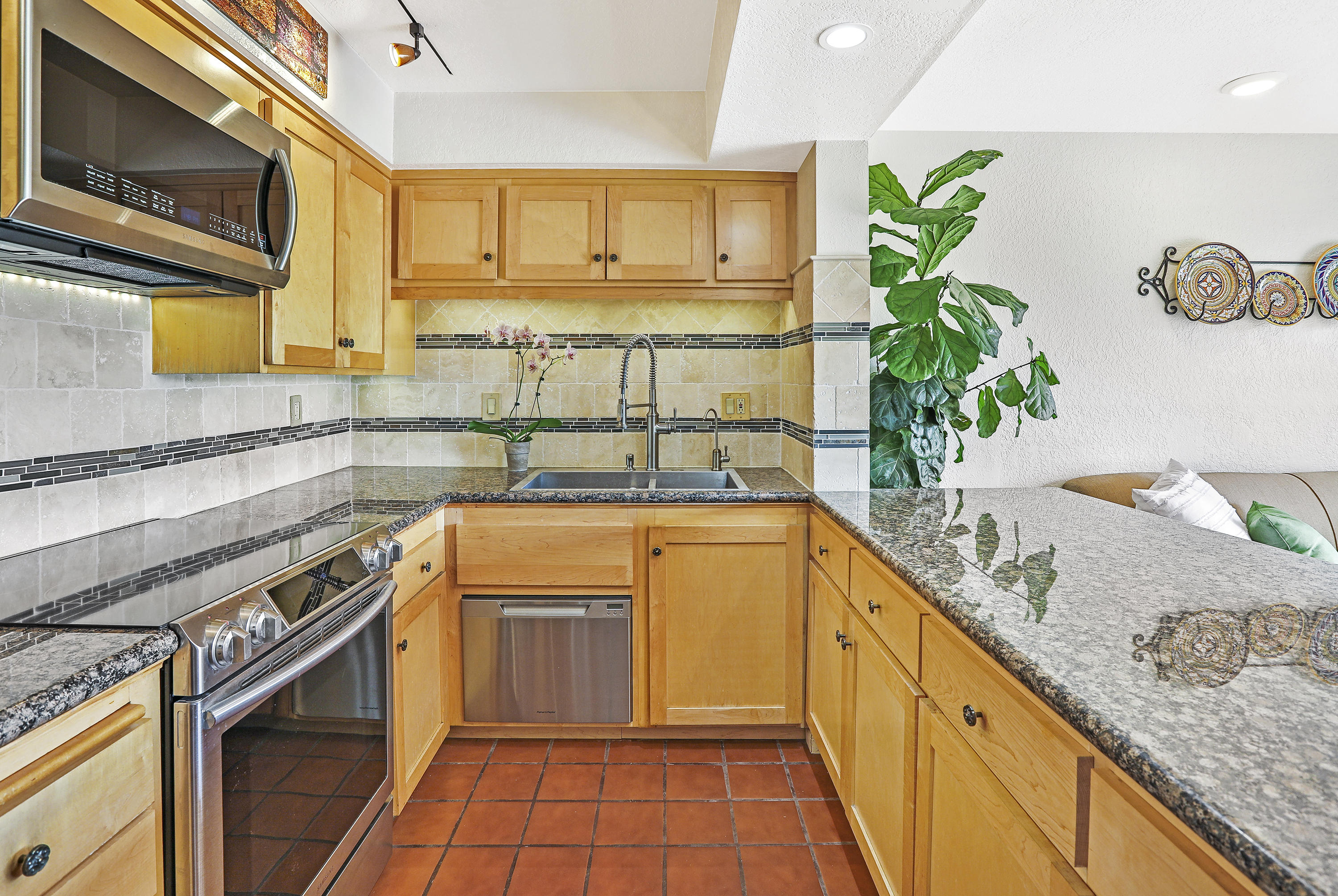 3375 Foothill Road, Unit 1012 Carpinteria, CA 93013 - Photo 3 of 15 a kitchen with stainless steel appliances granite countertop a sink a stove top oven a counter space and cabinets