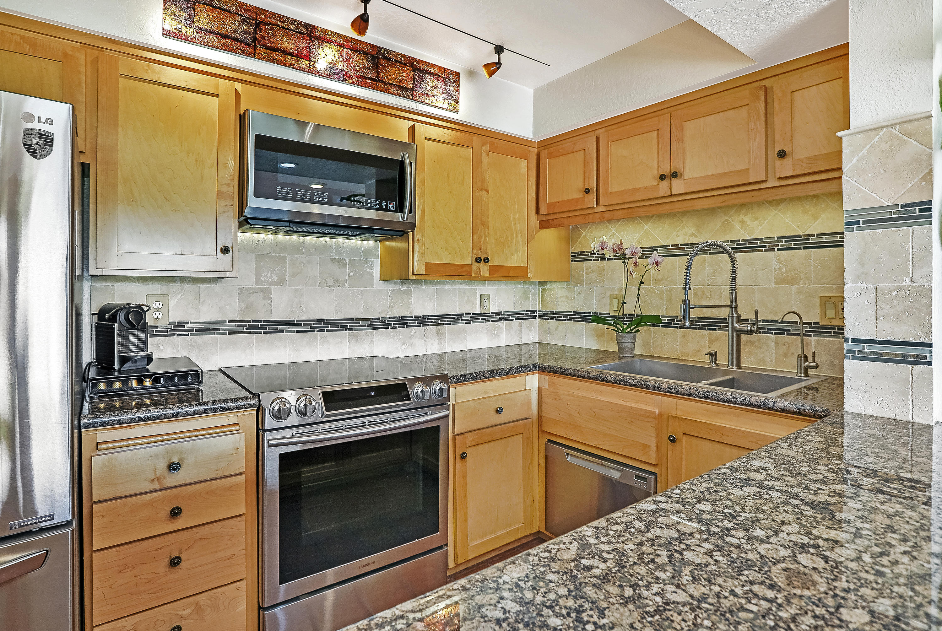 3375 Foothill Road, Unit 1012 Carpinteria, CA 93013 - Photo 4 of 15 a kitchen with granite countertop a stove and a sink