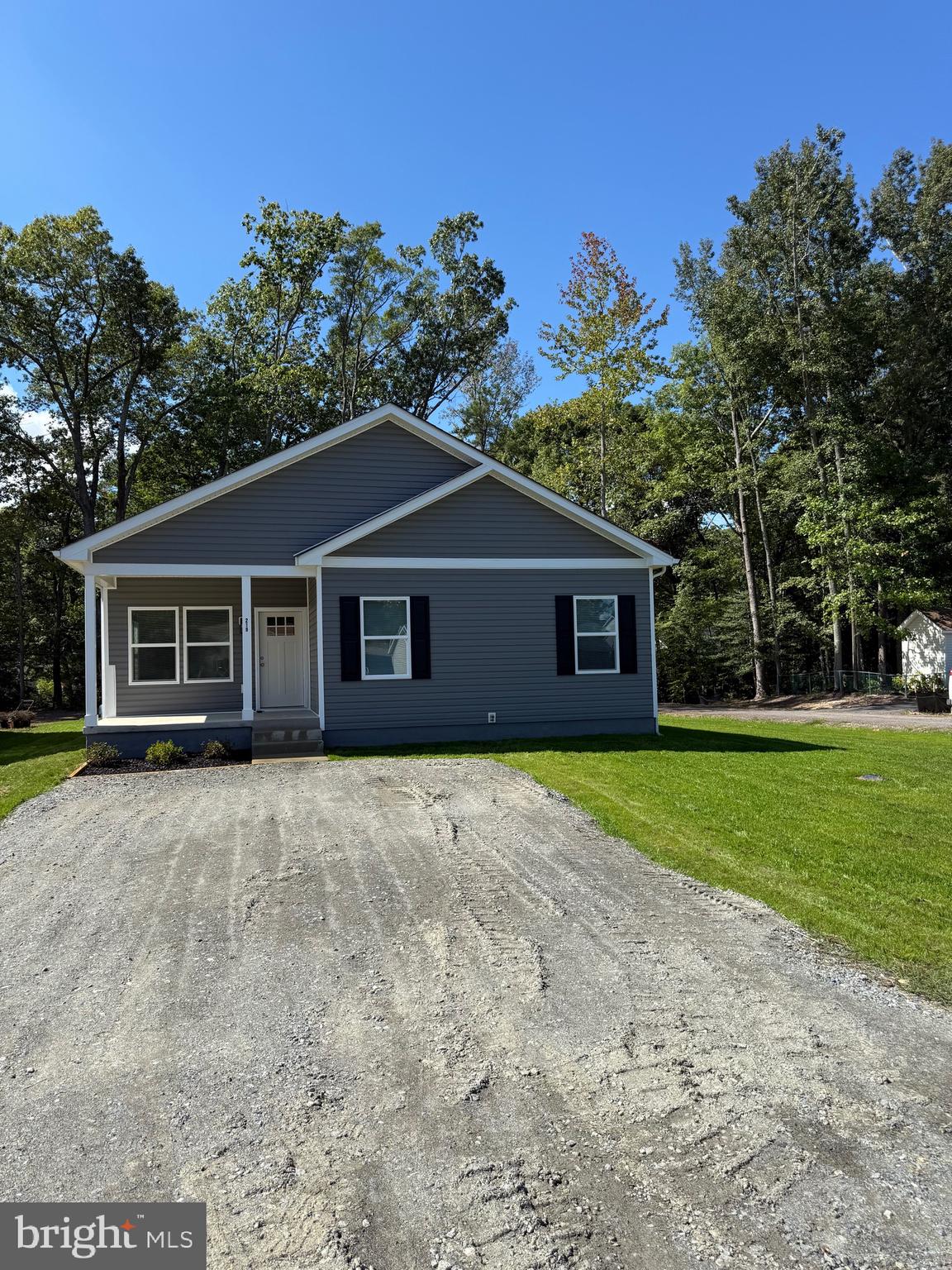 219 Holly Way Colonial Beach, VA 22443 - Photo 2 of 68 a front view of a house with a garden and trees