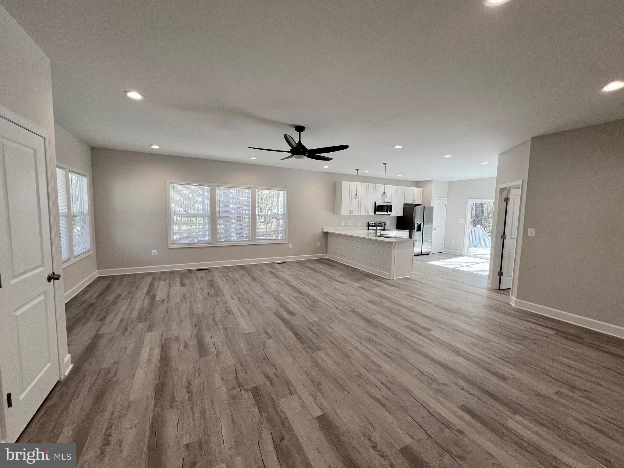 219 Holly Way Colonial Beach, VA 22443 - Photo 21 of 68 an empty room with wooden floor and windows