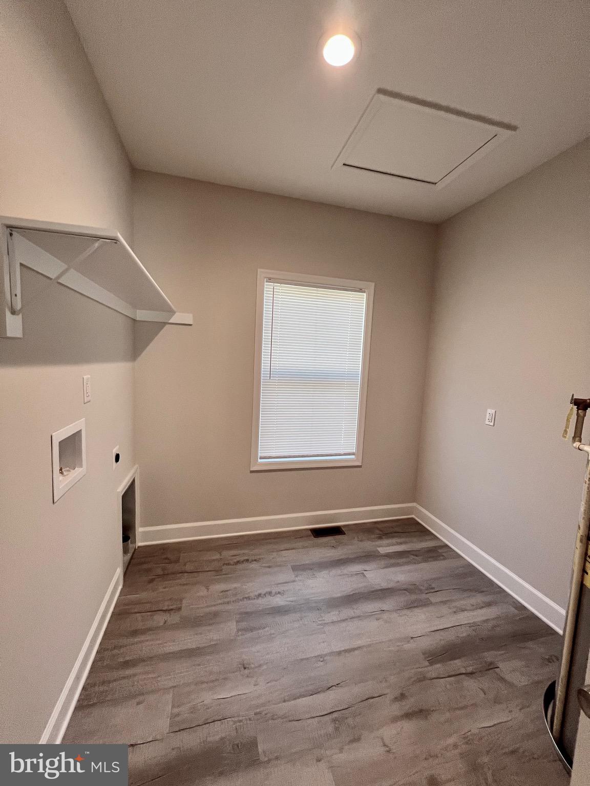 219 Holly Way Colonial Beach, VA 22443 - Photo 37 of 68 a view of an empty room with wooden floor and a window