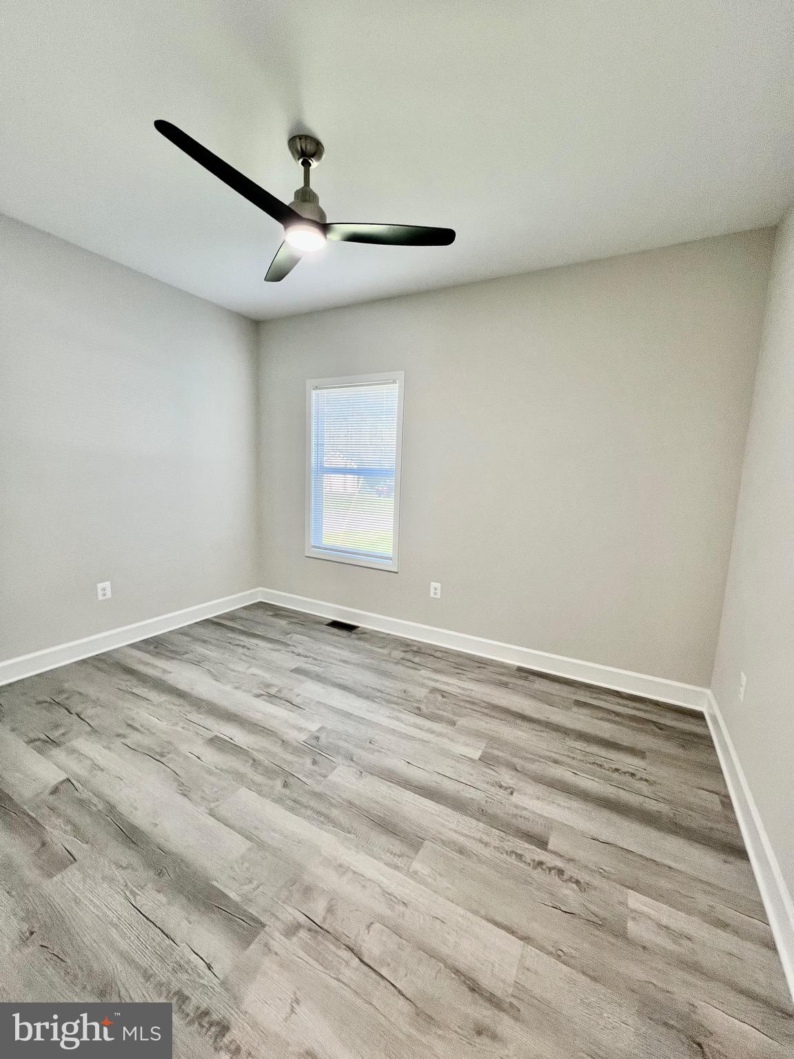 219 Holly Way Colonial Beach, VA 22443 - Photo 38 of 68 a view of empty room with wooden floor and fan