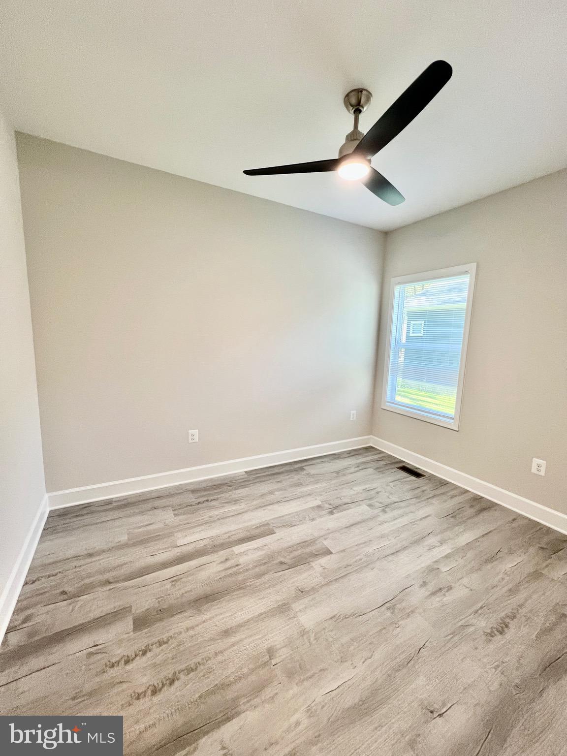 219 Holly Way Colonial Beach, VA 22443 - Photo 41 of 68 an empty room with wooden floor and windows