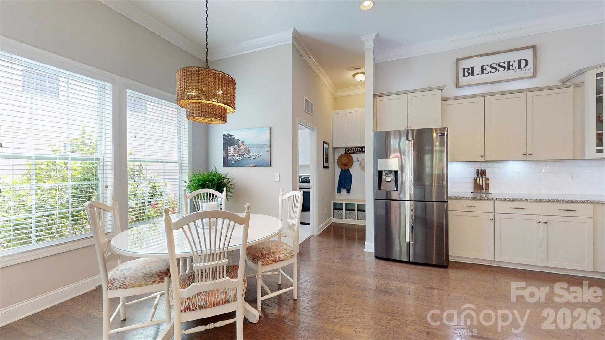 3036 Bridgewater Street Lancaster, SC 29720 - Photo 12 of 41 a kitchen with granite countertop a table chairs refrigerator and a view of living room