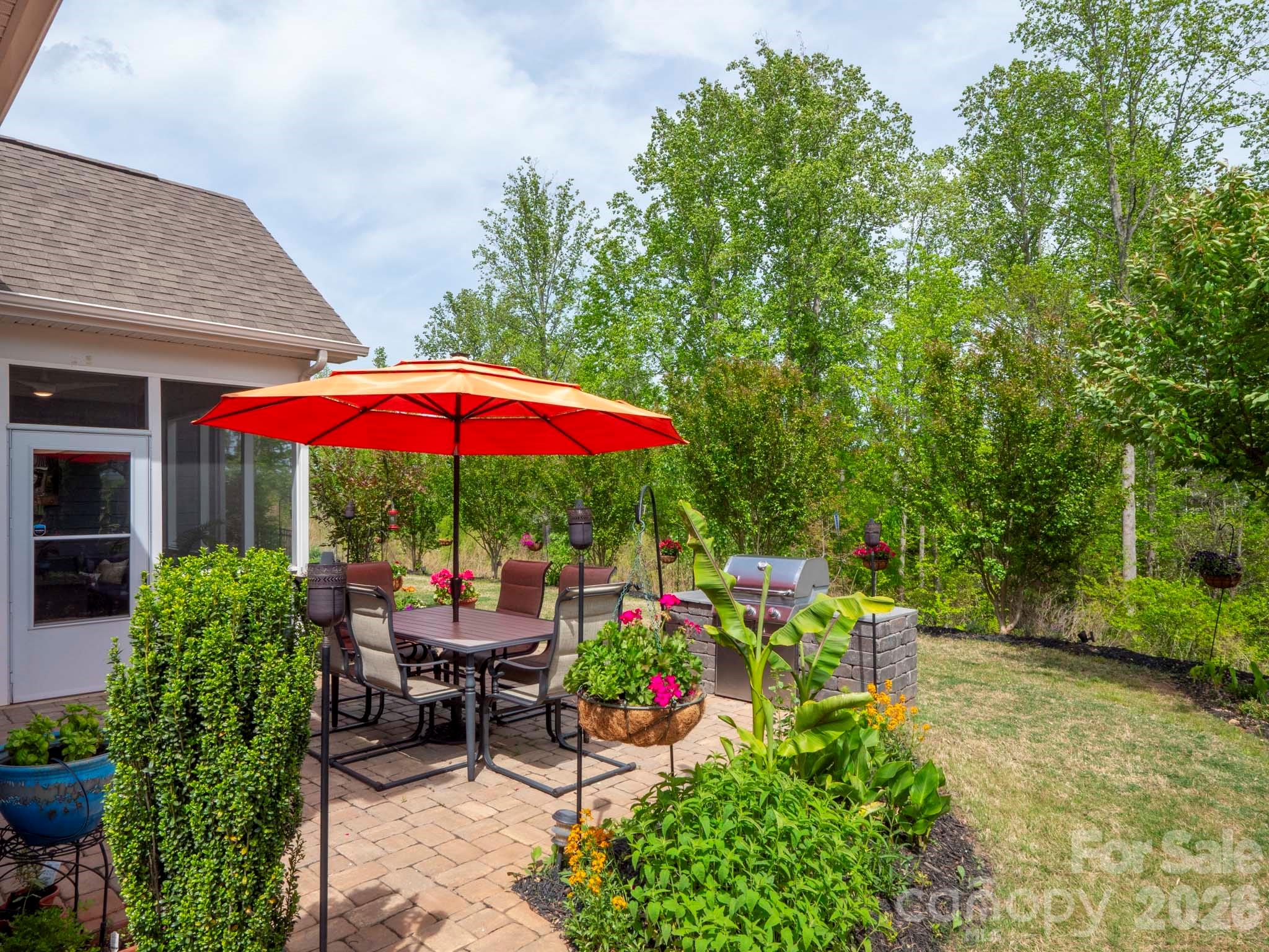 3036 Bridgewater Street Lancaster, SC 29720 - Photo 31 of 41 a view of a chair and table under an umbrella in backyard of house