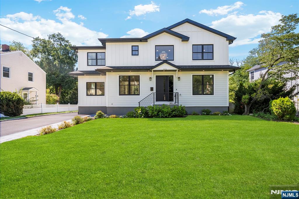 326 Northern Parkway Ridgewood, NJ 07450 - Photo 1 of 47 a front view of a house with a yard and garage