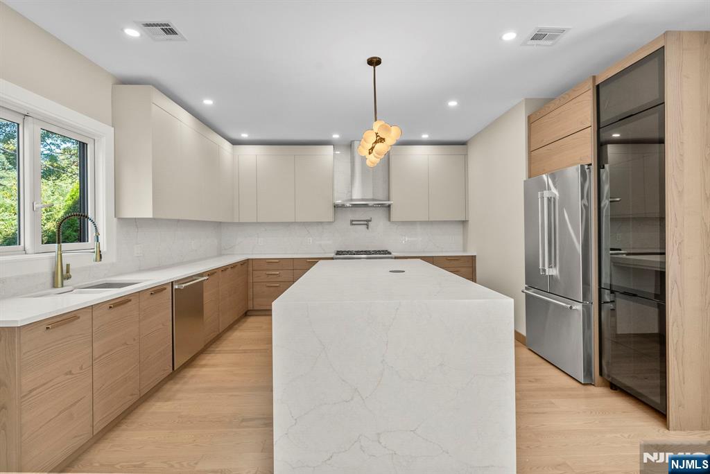 326 Northern Parkway Ridgewood, NJ 07450 - Photo 24 of 47 a large kitchen with stainless steel appliances kitchen island a large counter top a sink a refrigerator and a window