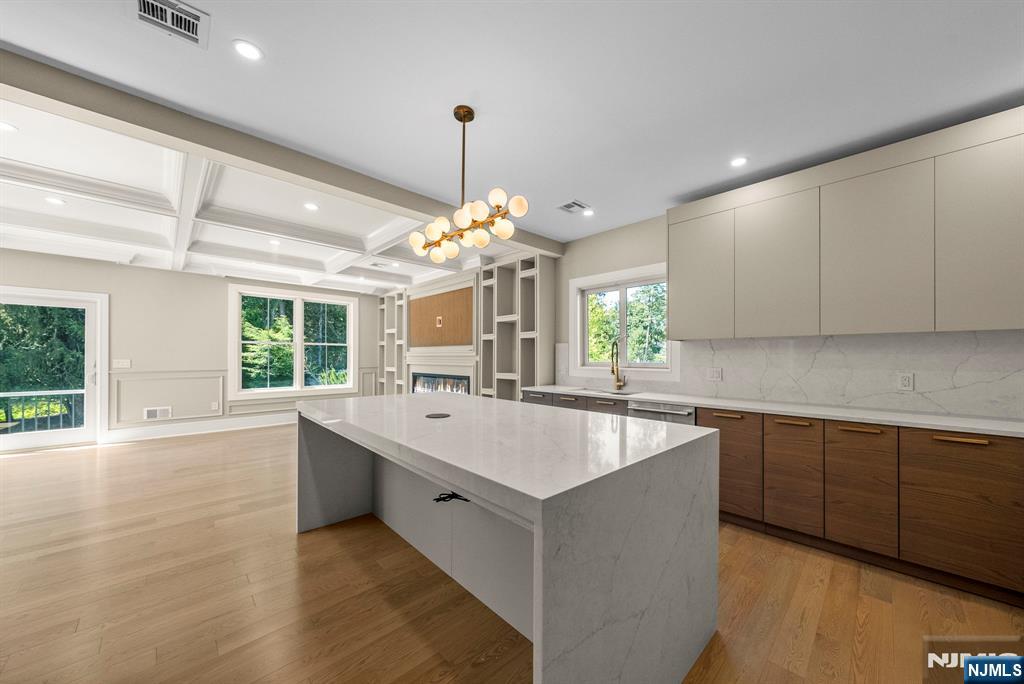 326 Northern Parkway Ridgewood, NJ 07450 - Photo 25 of 47 a large kitchen with kitchen island white cabinets and chandelier