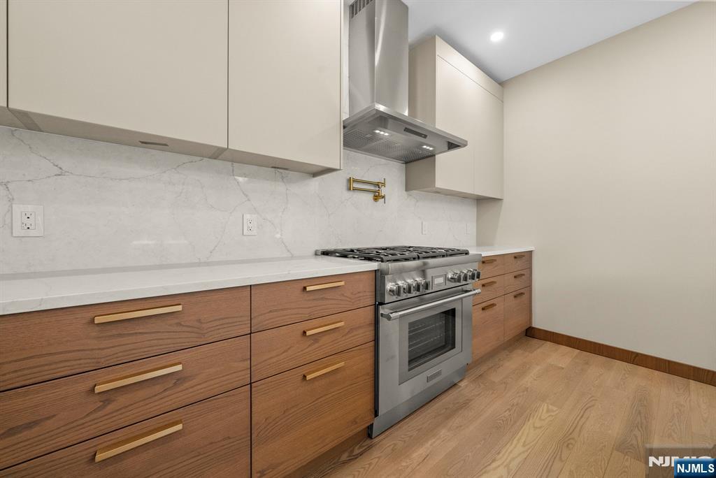 326 Northern Parkway Ridgewood, NJ 07450 - Photo 27 of 47 a kitchen with stainless steel appliances granite countertop a stove and a wooden floors