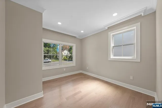 an empty room with windows and closet