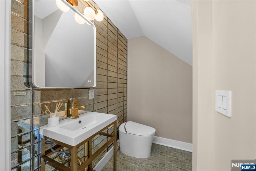 326 Northern Parkway Ridgewood, NJ 07450 - Photo 34 of 47 a bathroom with a sink a toilet and mirror