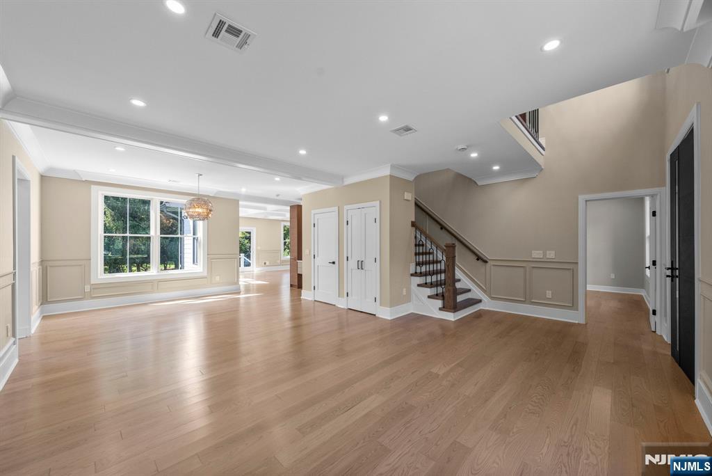 326 Northern Parkway Ridgewood, NJ 07450 - Photo 35 of 47 a view of an empty room with wooden floor stairs and a living room