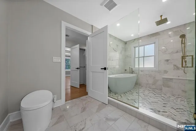 a bathroom with a toilet sink and shower
