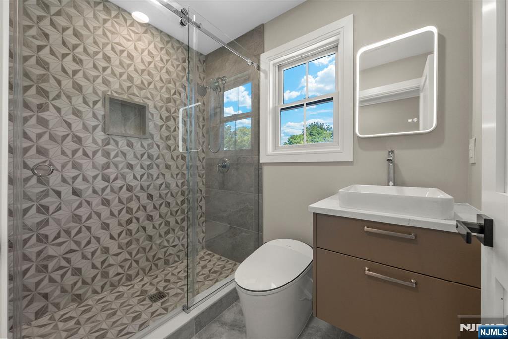 326 Northern Parkway Ridgewood, NJ 07450 - Photo 10 of 30 a bathroom with a sink a toilet and a mirror