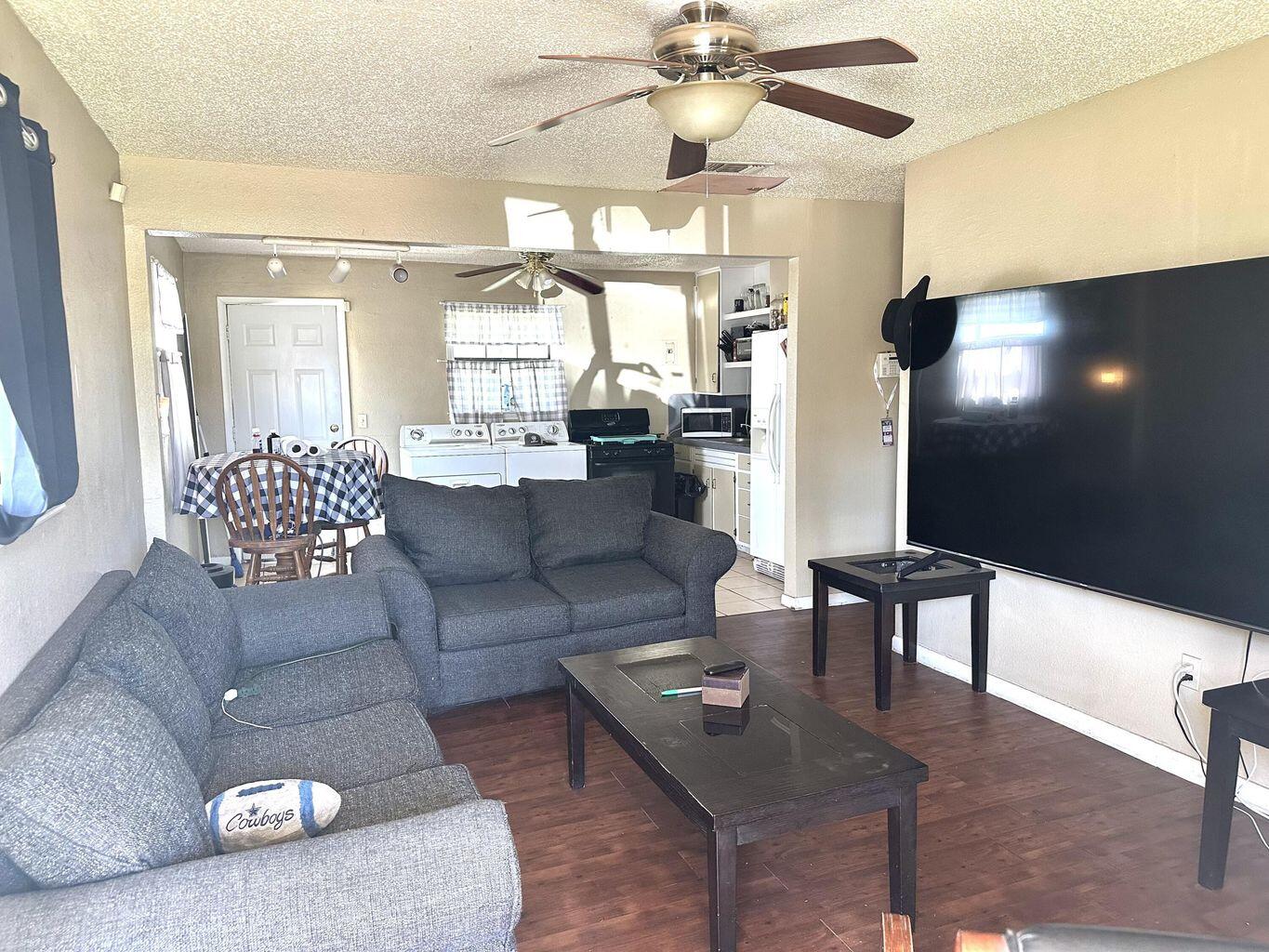 412 West 29th Plainview, TX 79072 - Photo 2 of 9 a living room with furniture and a chandelier