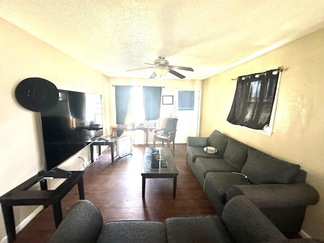 412 West 29th Plainview, TX 79072 - Photo 3 of 9 a living room with furniture and a chandelier