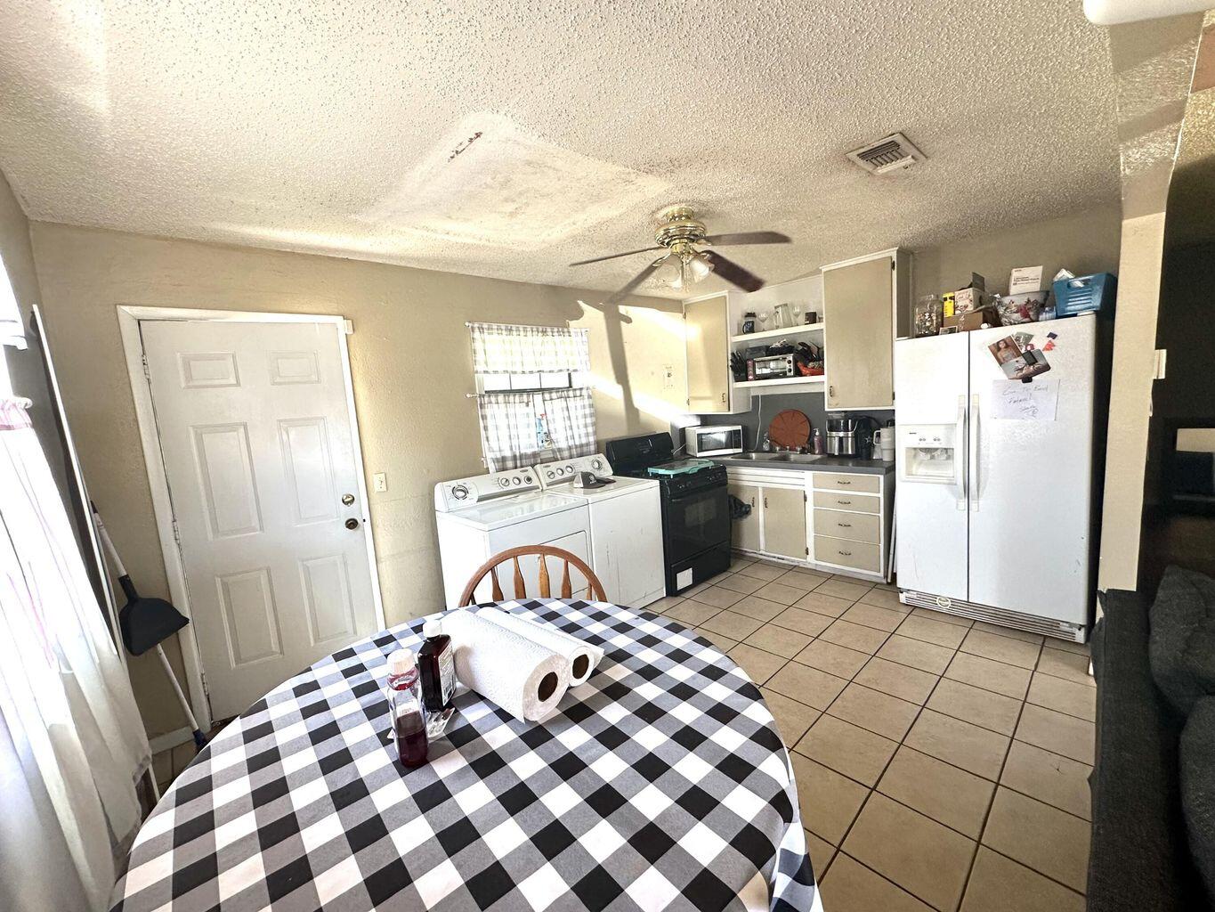 412 West 29th Plainview, TX 79072 - Photo 4 of 9 a kitchen with a refrigerator and a stove top oven