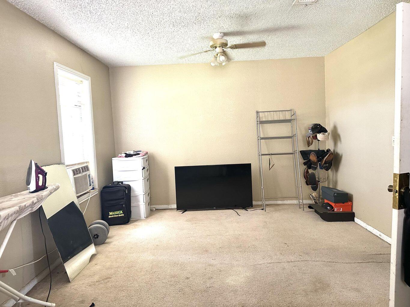 412 West 29th Plainview, TX 79072 - Photo 5 of 9 a bedroom with a bed and a chandelier