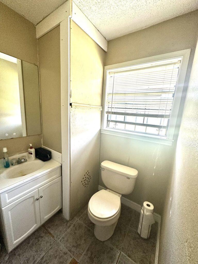 412 West 29th Plainview, TX 79072 - Photo 8 of 9 a bathroom with a toilet a sink and a mirror