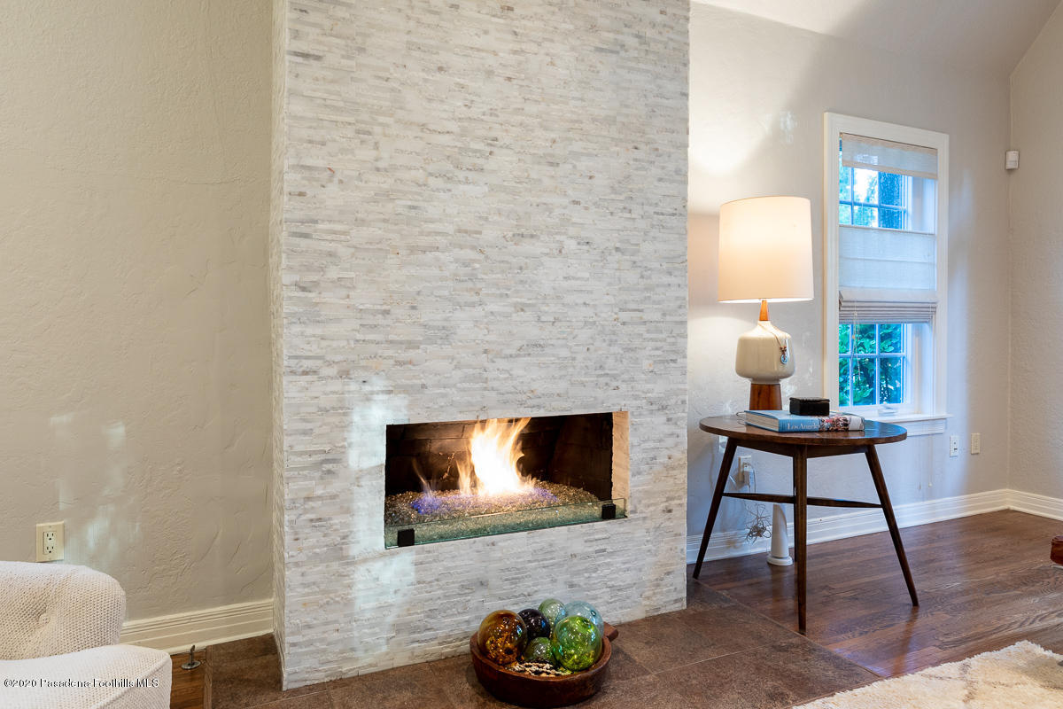 72 Annandale Road Pasadena, CA 91105 - Photo 9 of 45 a living room with furniture a flat screen tv and a fireplace