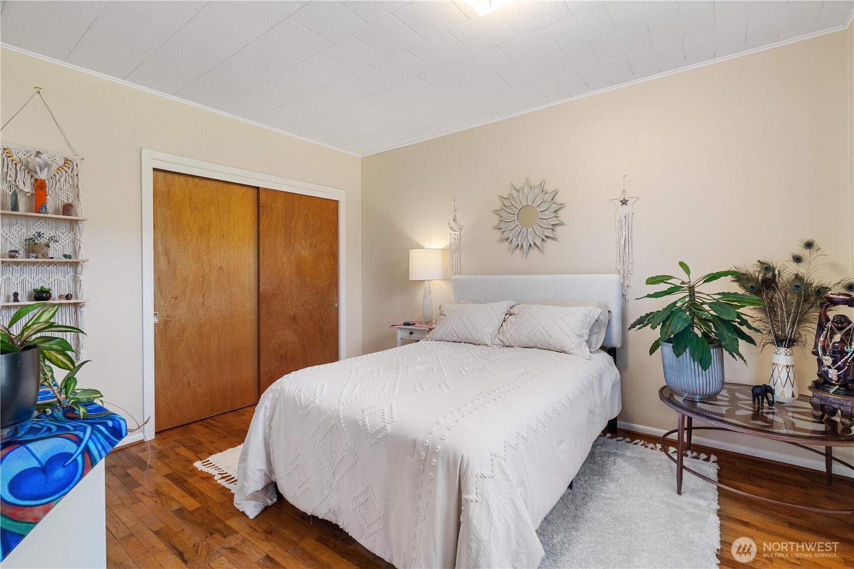 Undisclosed Address Forks, WA 98331 - Photo 18 of 39 a bedroom with bed and a potted plant
