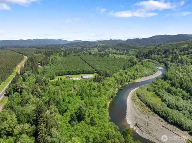 a backyard of a house with lots of green space and fountain