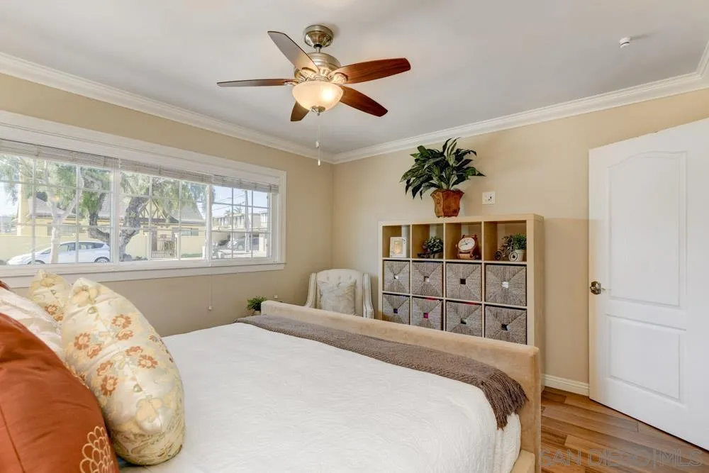 1221 4th Street Coronado, CA 92118 - Photo 13 of 24 a bedroom with a large bed and a large window