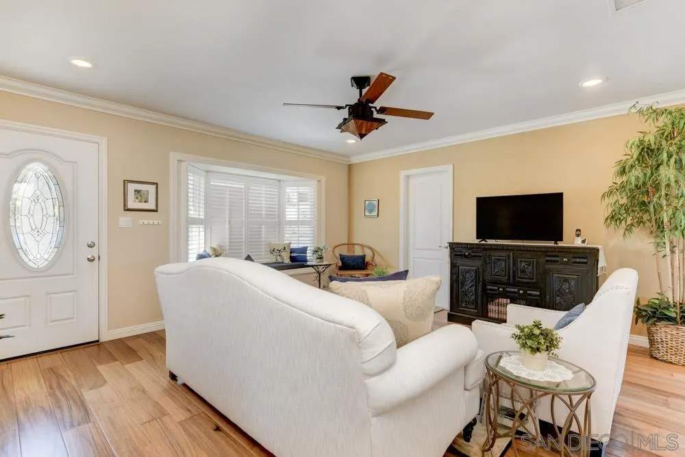 1221 4th Street Coronado, CA 92118 - Photo 8 of 24 a living room with furniture a flat screen tv and a window