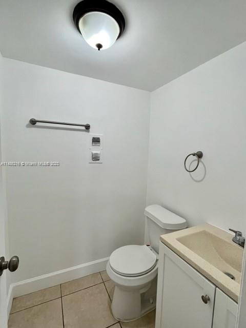 14155 Southwest 87th Street, Unit E310 Miami, FL 33183 - Photo 12 of 13 a bathroom with a granite countertop toilet and a sink