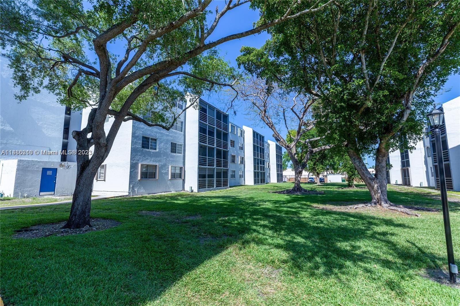 14155 Southwest 87th Street, Unit E310 Miami, FL 33183 - Photo 13 of 13 a view of a house with a yard