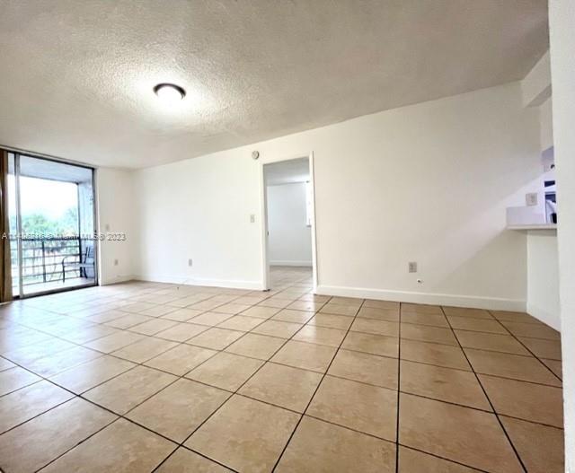 14155 Southwest 87th Street, Unit E310 Miami, FL 33183 - Photo 6 of 13 a view of an empty room and window
