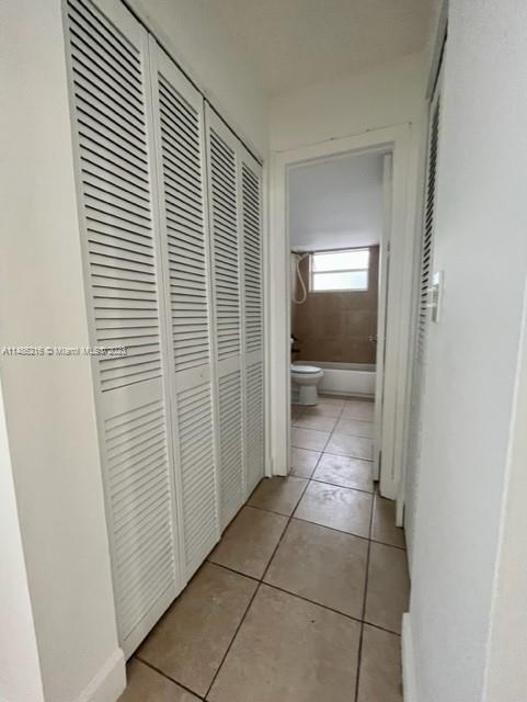 14155 Southwest 87th Street, Unit E310 Miami, FL 33183 - Photo 8 of 13 a view of a hallway to rooms