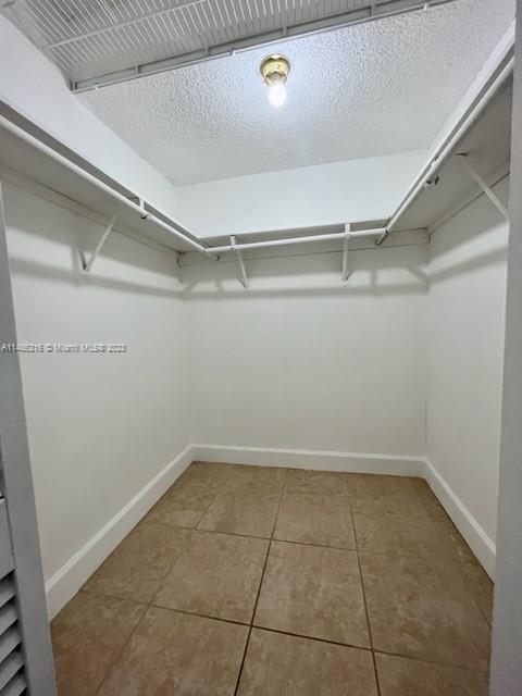 14155 Southwest 87th Street, Unit E310 Miami, FL 33183 - Photo 9 of 13 a view of a room with racks on the wall