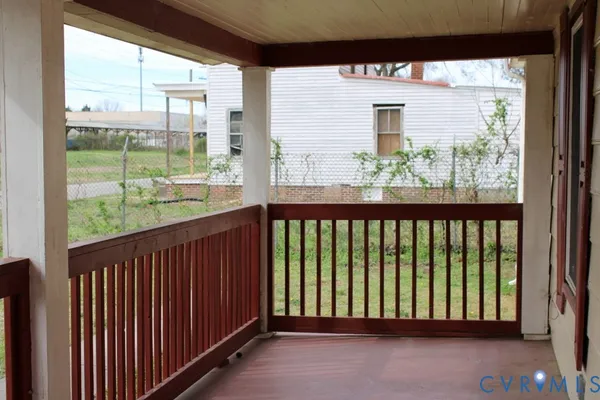 a view of a brick house with large windows and a large tree