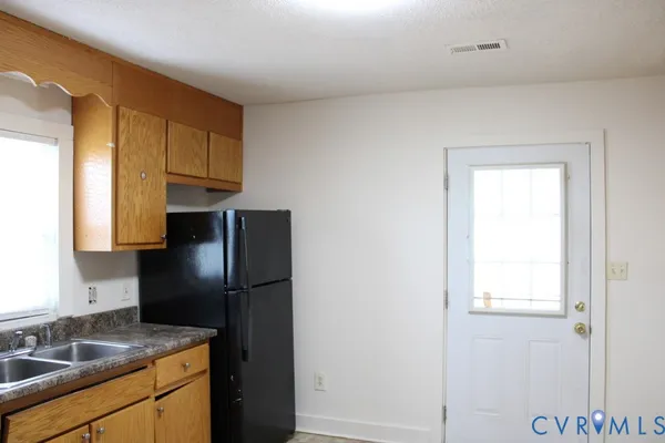 a kitchen with a refrigerator and a sink