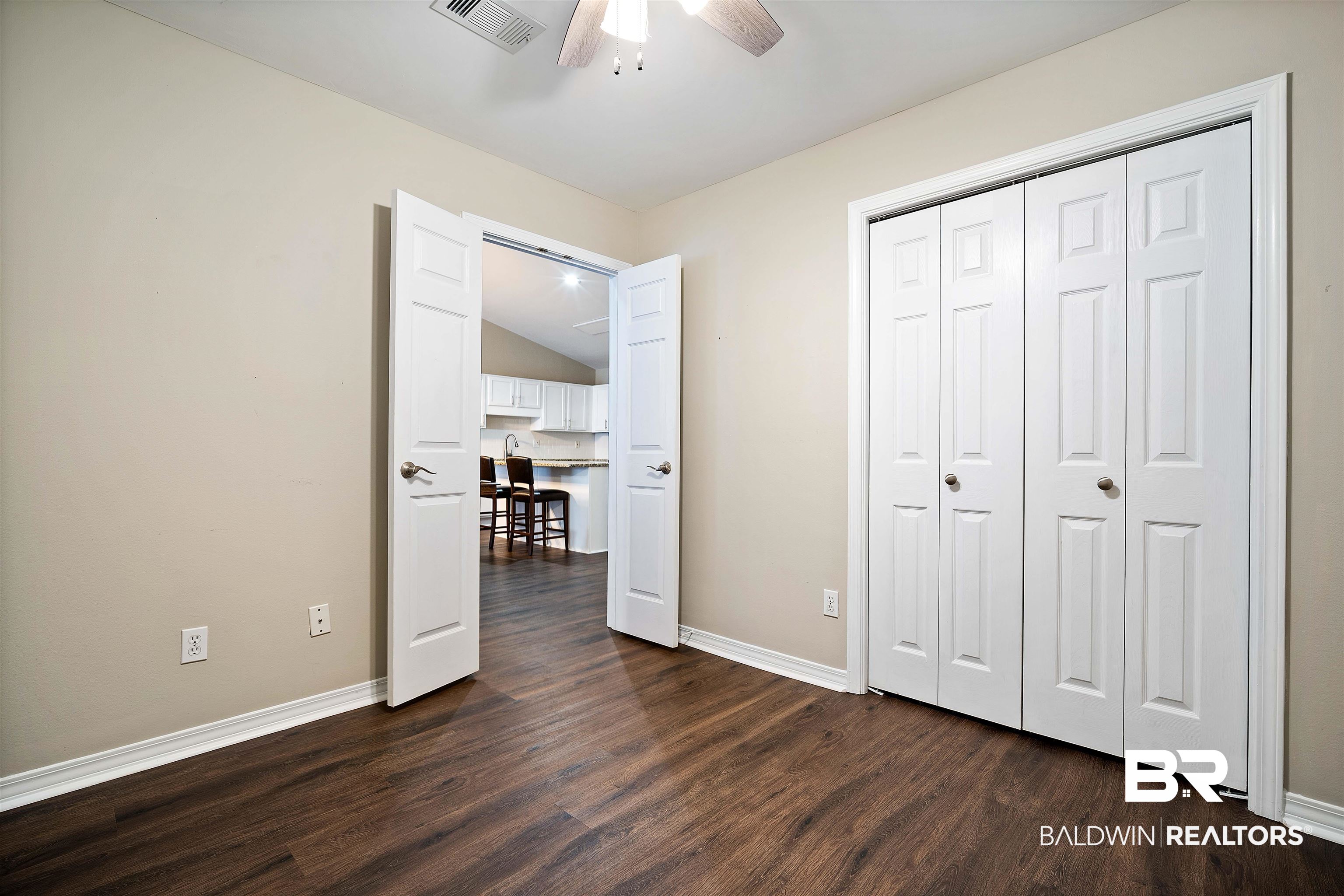 628 Spring Lake Court Mobile, AL 36695 - Photo 13 of 25 Unfurnished bedroom featuring dark hardwood / wood-style flooring, a closet, and ceiling fan