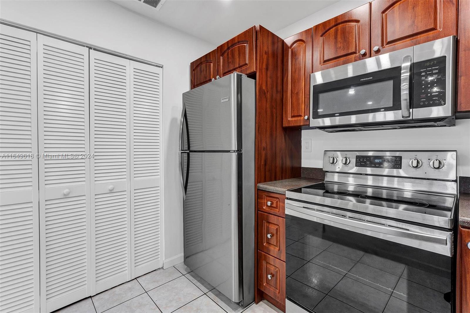 13240 Southwest 17th Lane, Unit 8 Miami, FL 33175 - Photo 4 of 14 a kitchen with stainless steel appliances and refrigerator