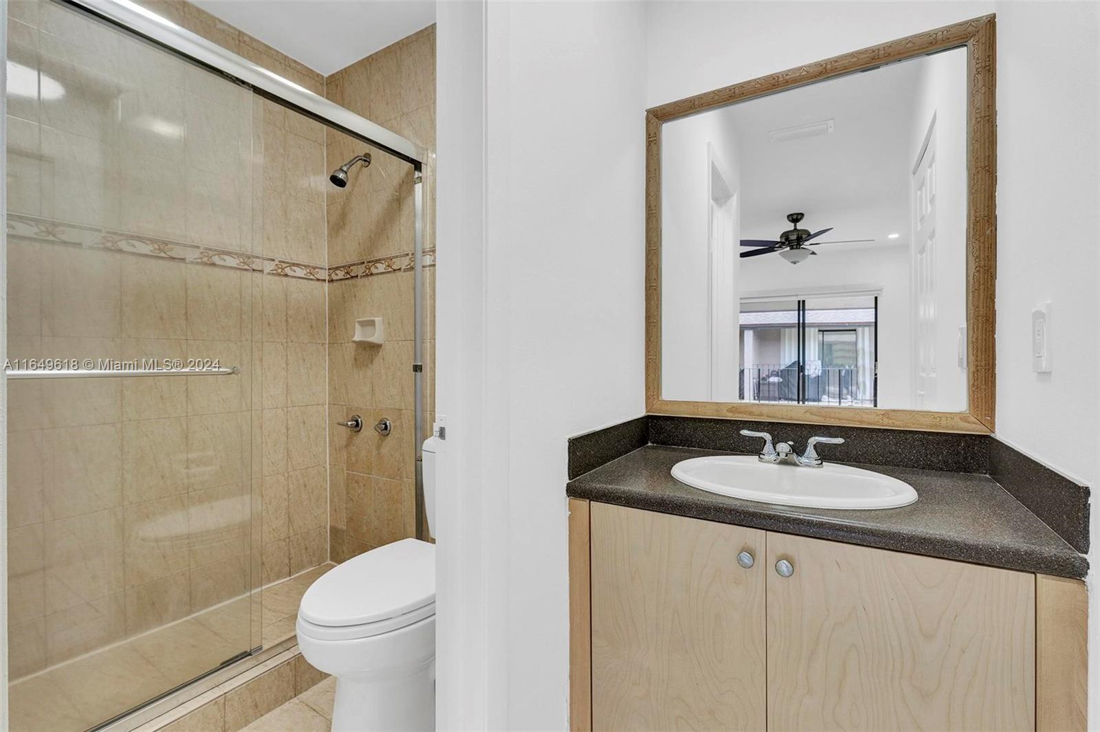 13240 Southwest 17th Lane, Unit 8 Miami, FL 33175 - Photo 10 of 14 a bathroom with a granite countertop sink toilet and shower
