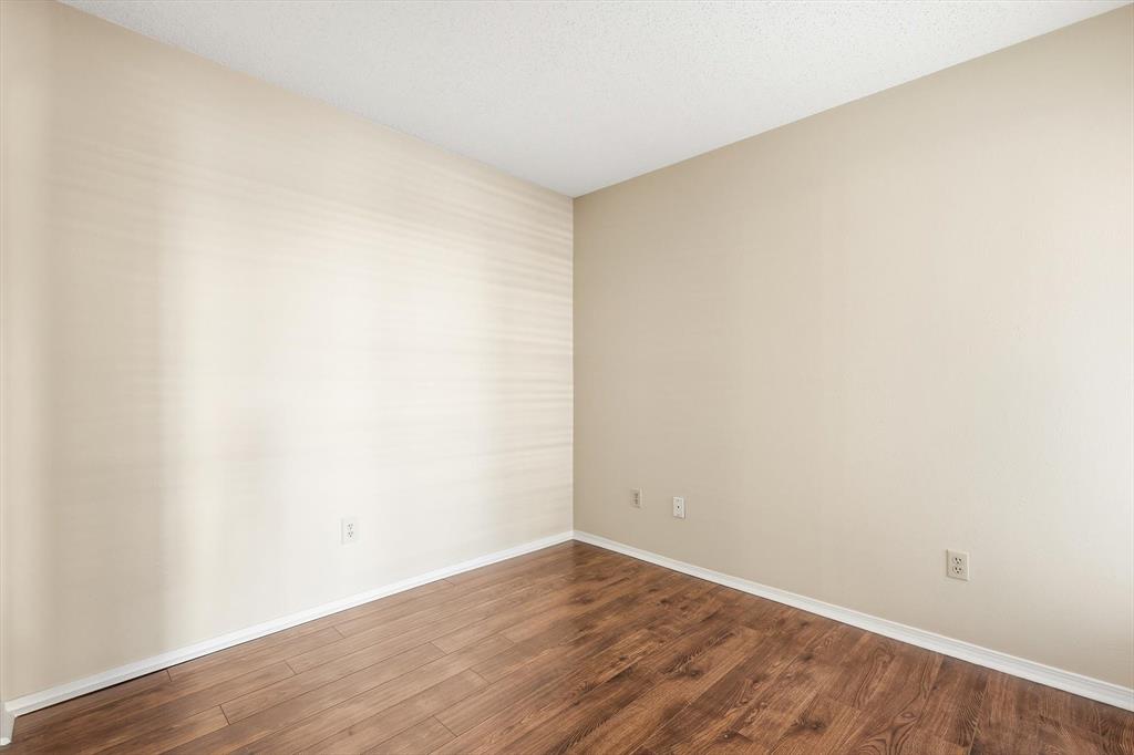 18333 Roehampton Drive, Unit 716 Dallas, TX 75252 - Photo 16 of 24 a view of an empty room with wooden floor