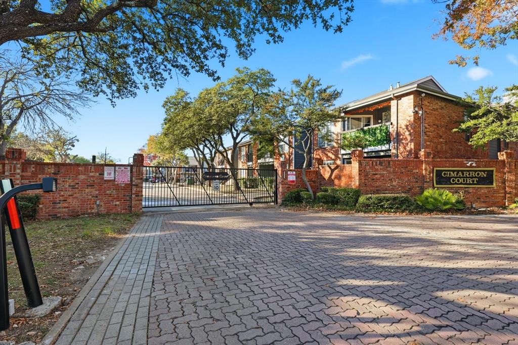 18333 Roehampton Drive, Unit 716 Dallas, TX 75252 - Photo 2 of 24 a view of a street with a building and trees in the background
