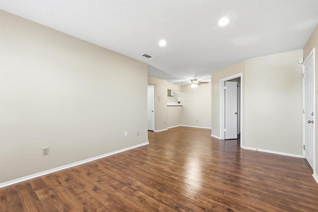 18333 Roehampton Drive, Unit 716 Dallas, TX 75252 - Photo 8 of 24 a view of empty room with wooden floor