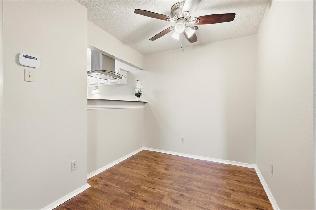 18333 Roehampton Drive, Unit 716 Dallas, TX 75252 - Photo 9 of 24 an empty room with wooden floor fan and windows