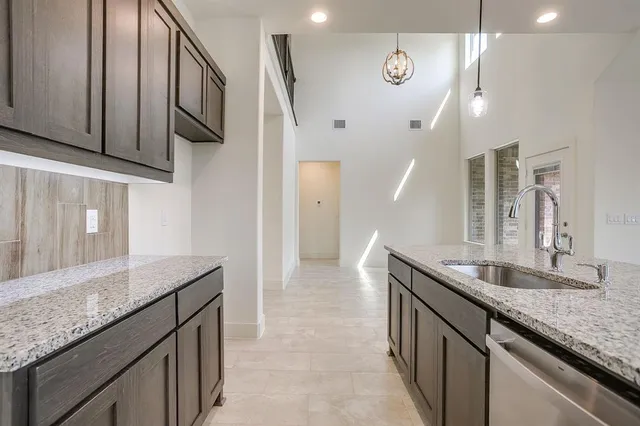 a kitchen with stainless steel appliances granite countertop a sink and stove