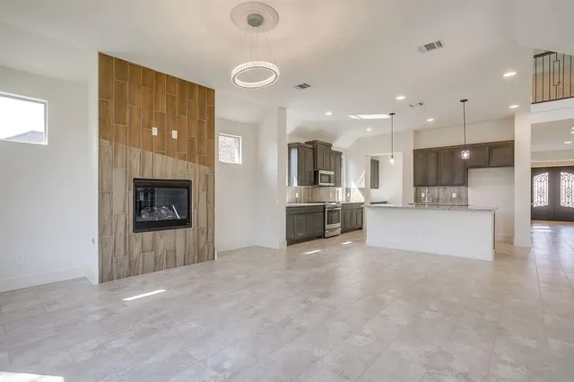 a view of kitchen and kitchen with furniture and a fireplace