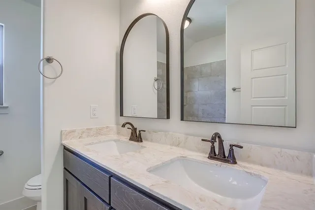 a bathroom with a double vanity sink and a mirror