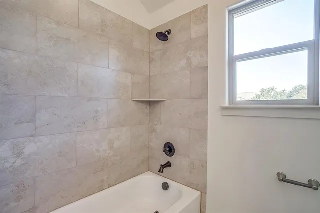a bathroom with a tub and a window