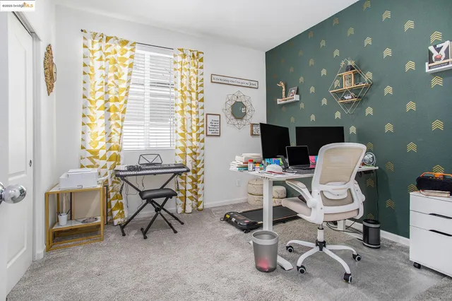 a kitchen with stainless steel appliances granite countertop a stove top oven a sink dishwasher a dining table and chairs with wooden floor